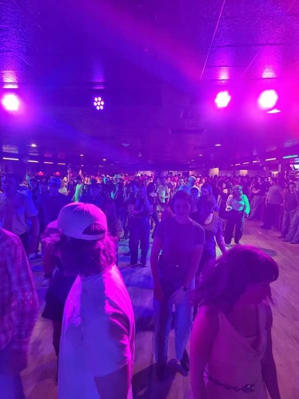 A full dance floor under colored lights